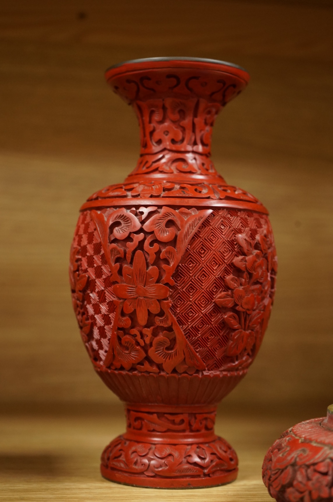 Two Chinese cinnabar lacquer vases and an ashtray, largest 20cm high